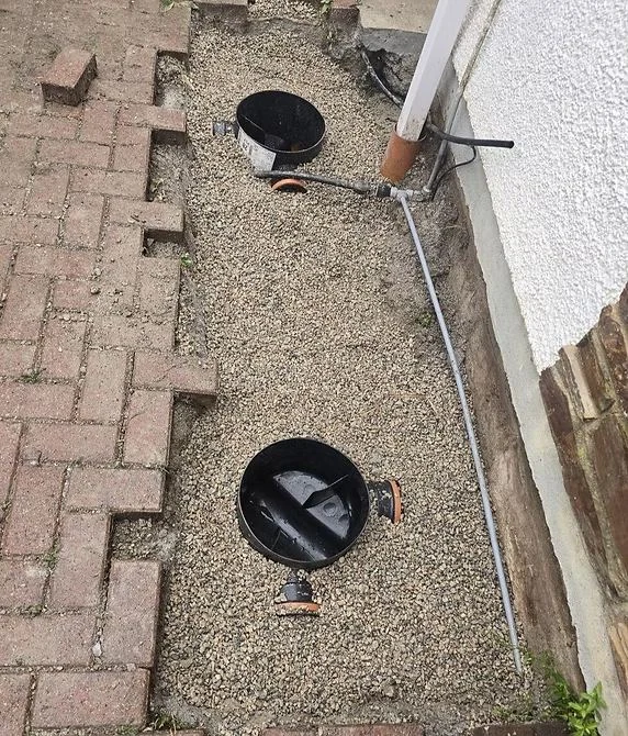 New drainage manhole covers installed in block paving